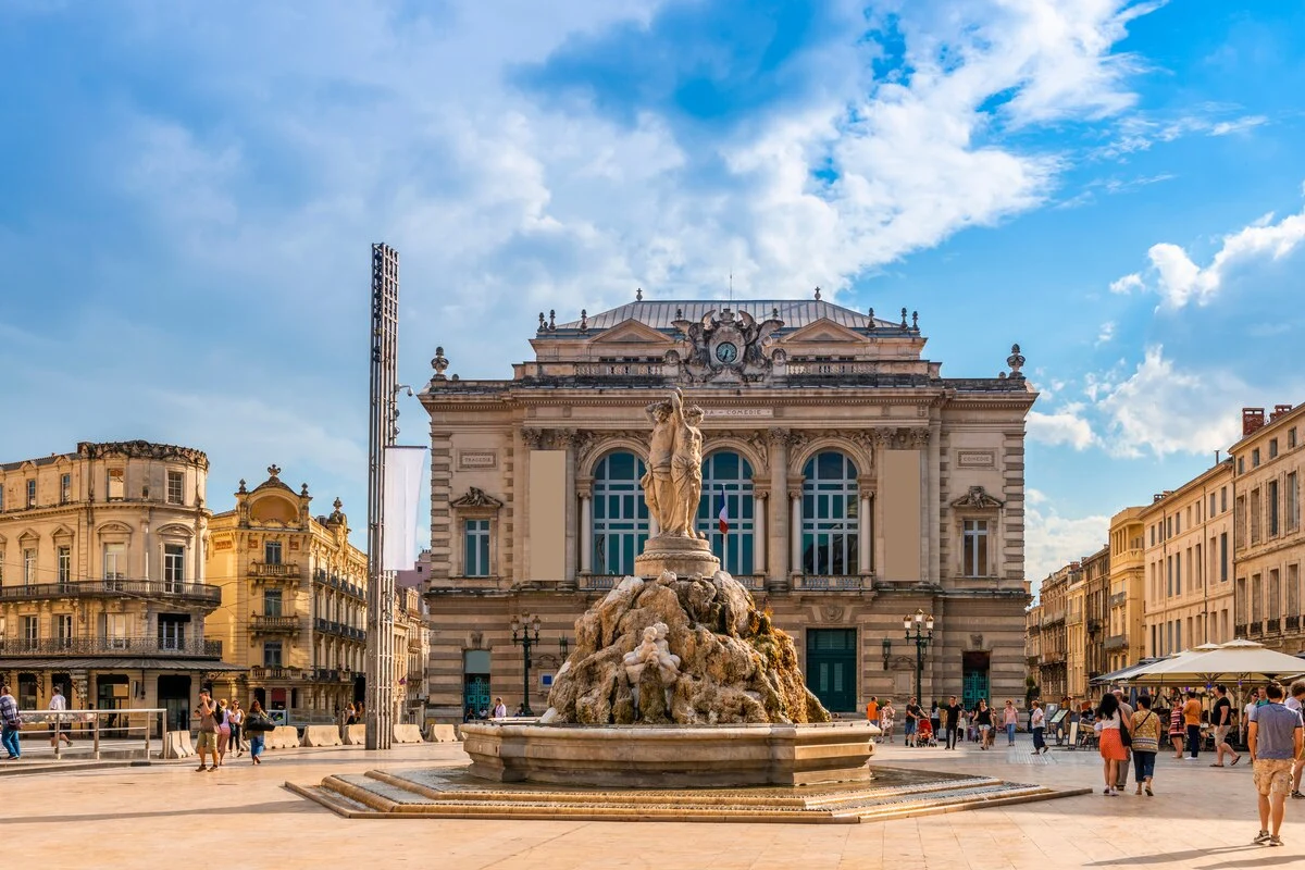 La Place de la Comédie à Montpellier avec l’Opéra et la fontaine des Trois Grâces sous un ciel ensoleillé